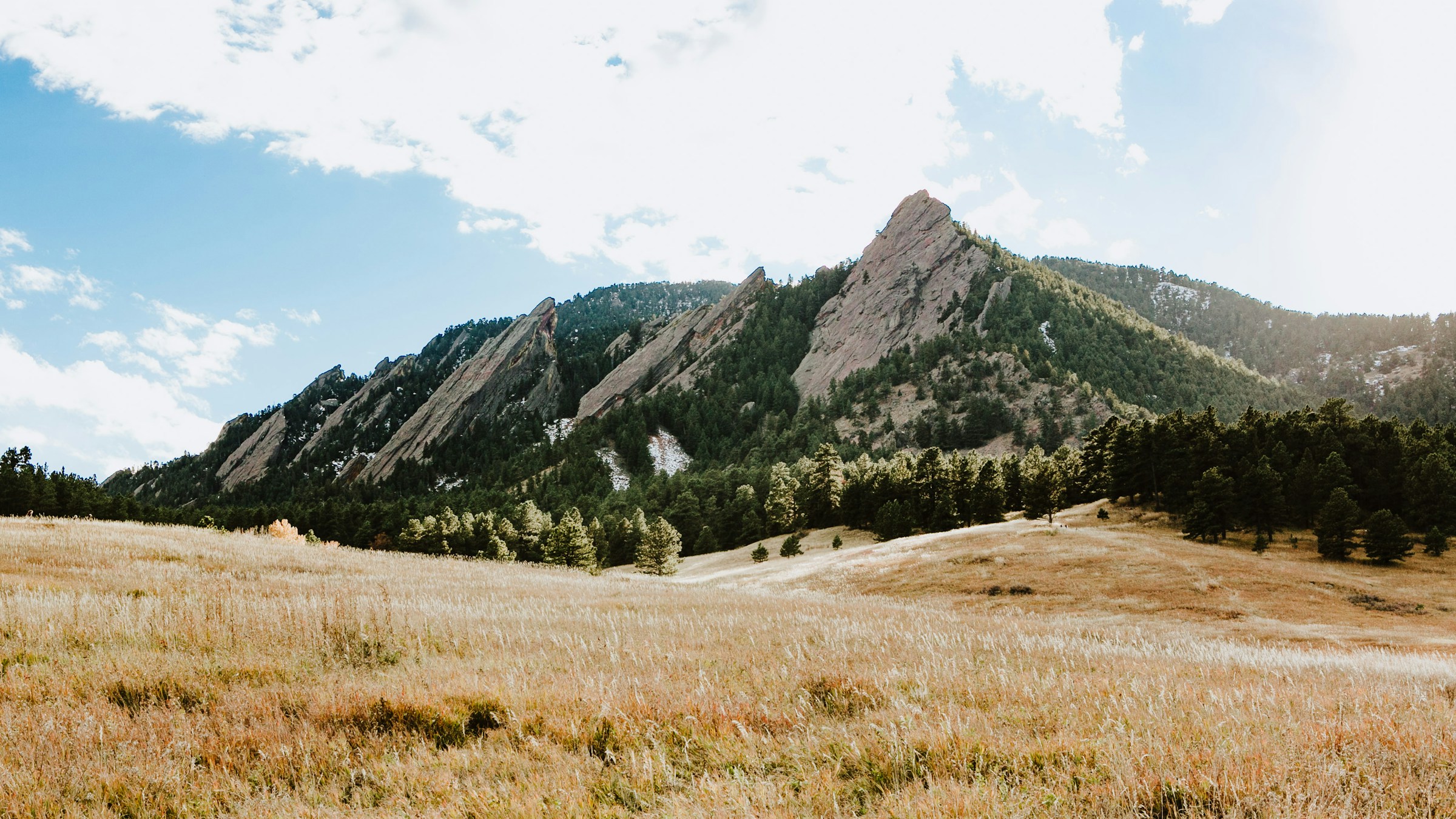 The Flatirons above a sunlit meadow in Boulder, Colorado